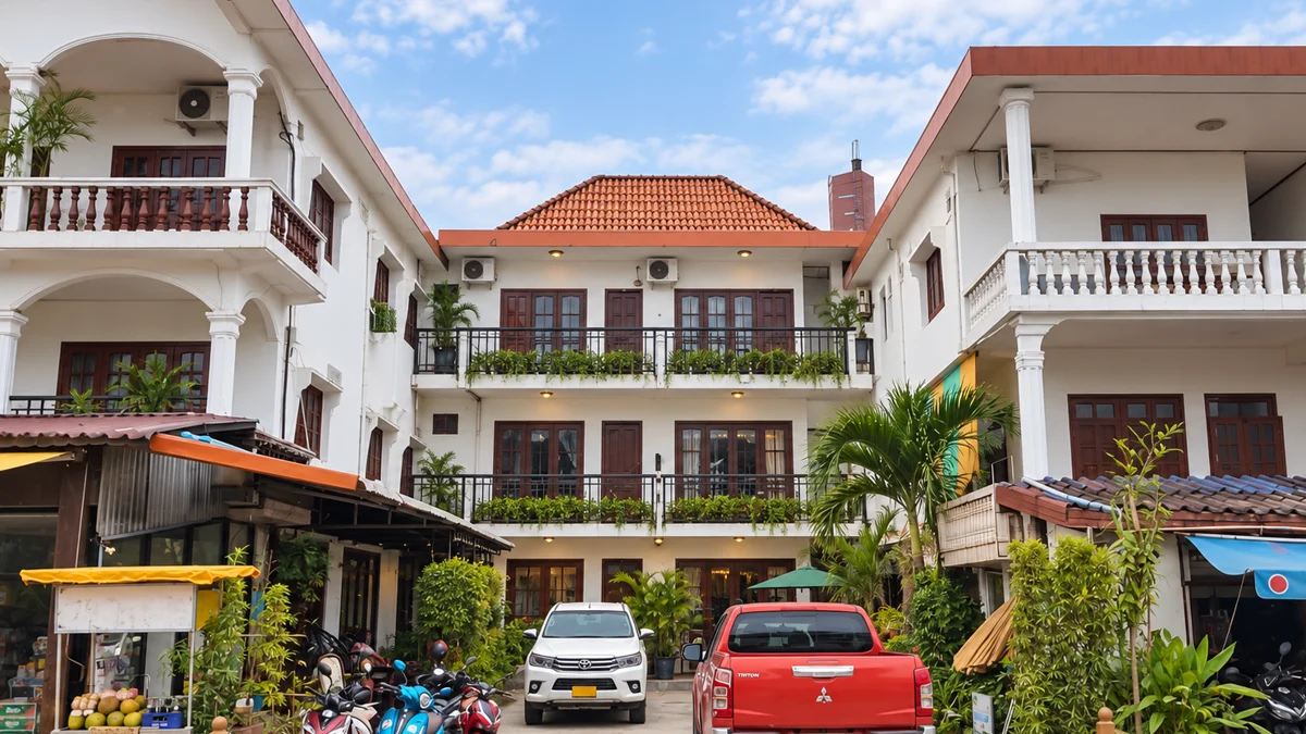 The hotel exterior with white balconies and terracotta roof tiles