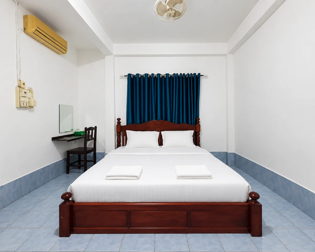 A front view of a wooden bed and blue curtains in a Florian room