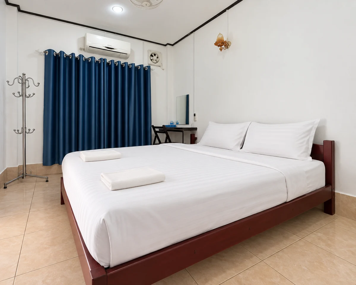 A Florian guest room with a wooden bed, white linen and blue curtains